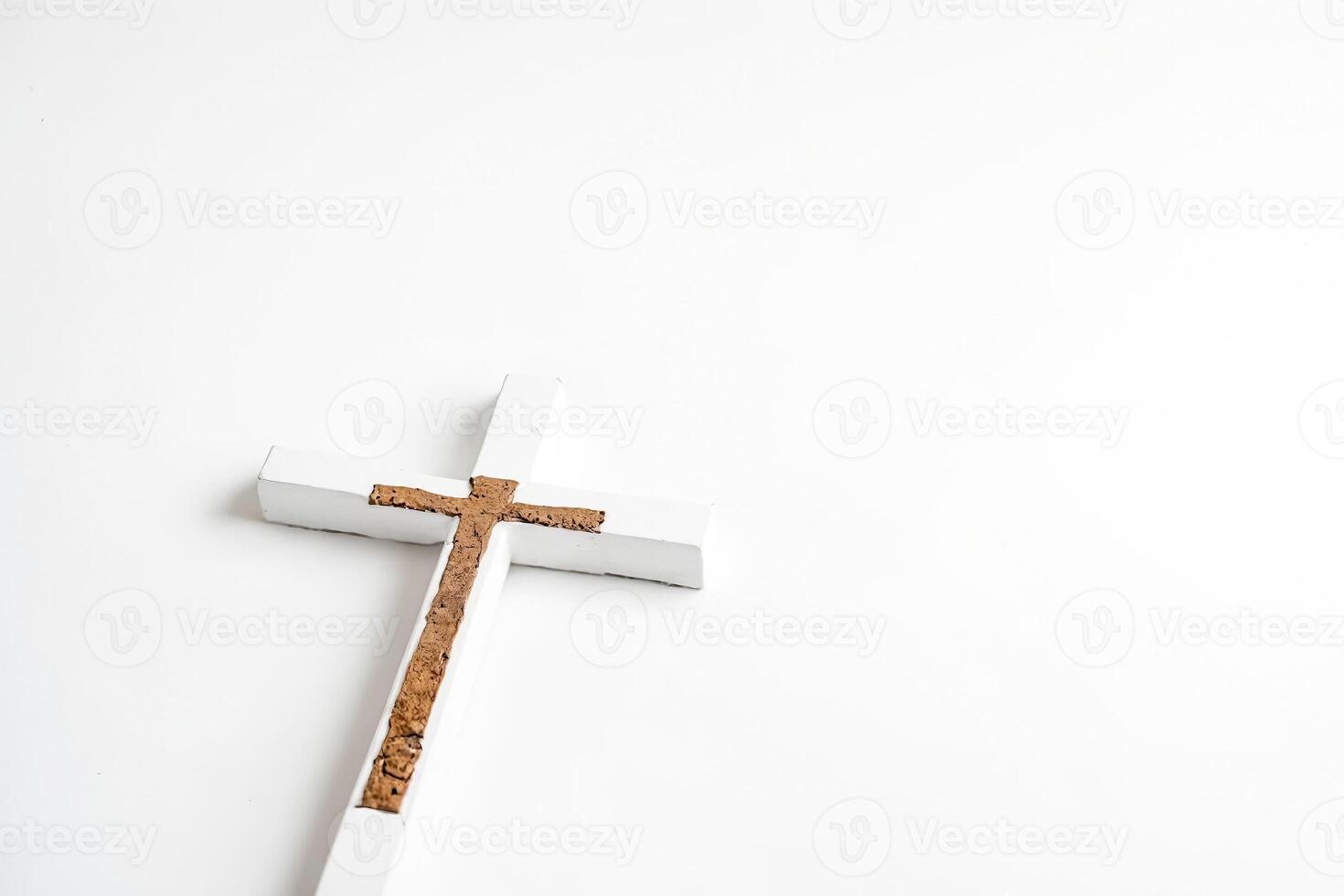 White Wooden Cross with Brown Center on White Background photo