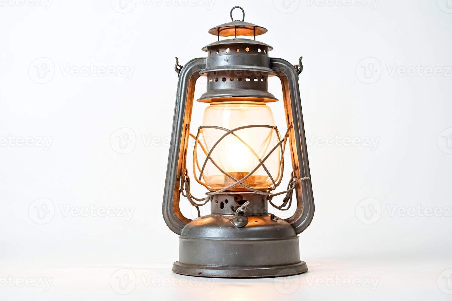 Antique Kerosene Lantern with Warm Glow on a White Background photo