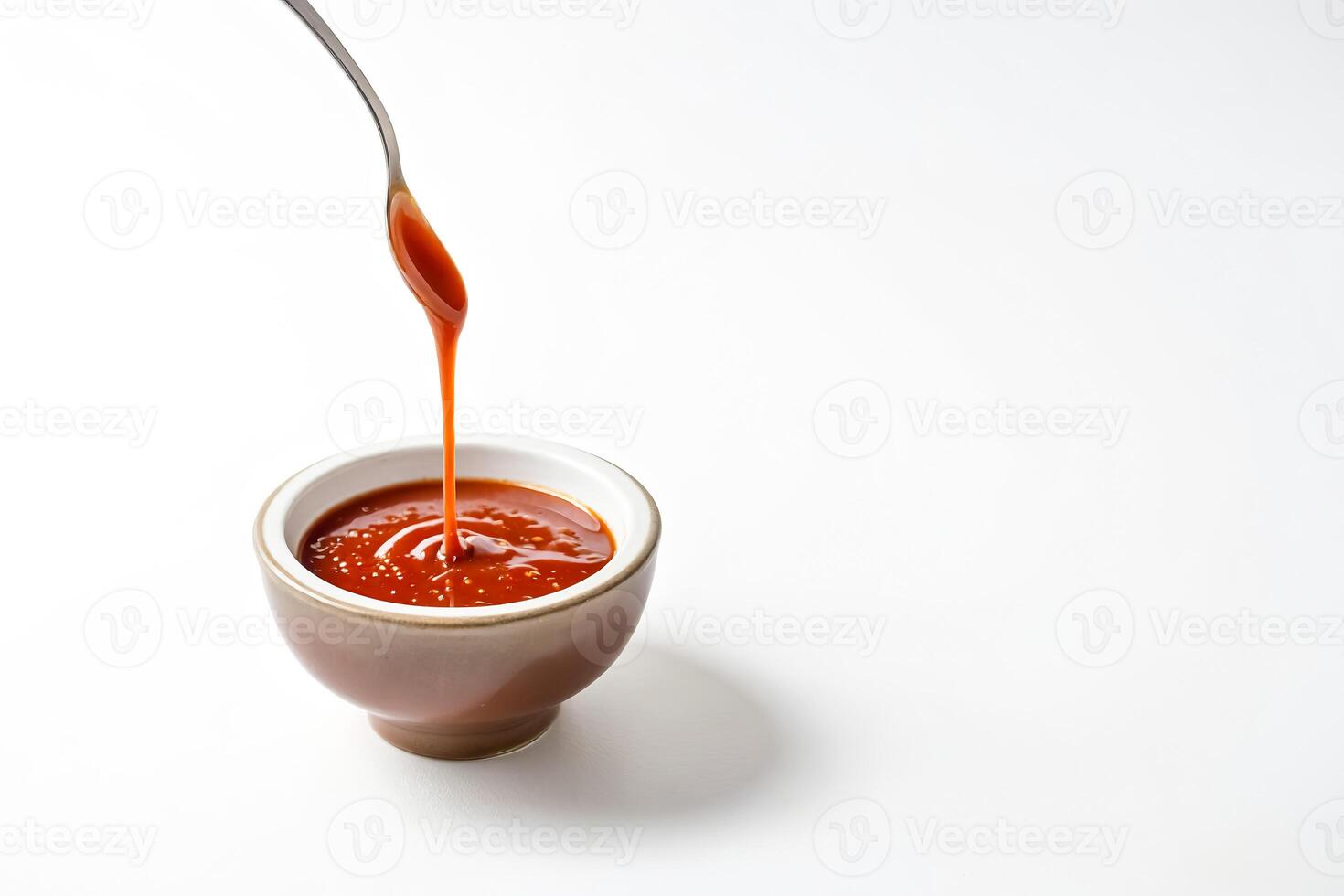 Close-up of Caramel Sauce Drizzling into a Small Bowl photo