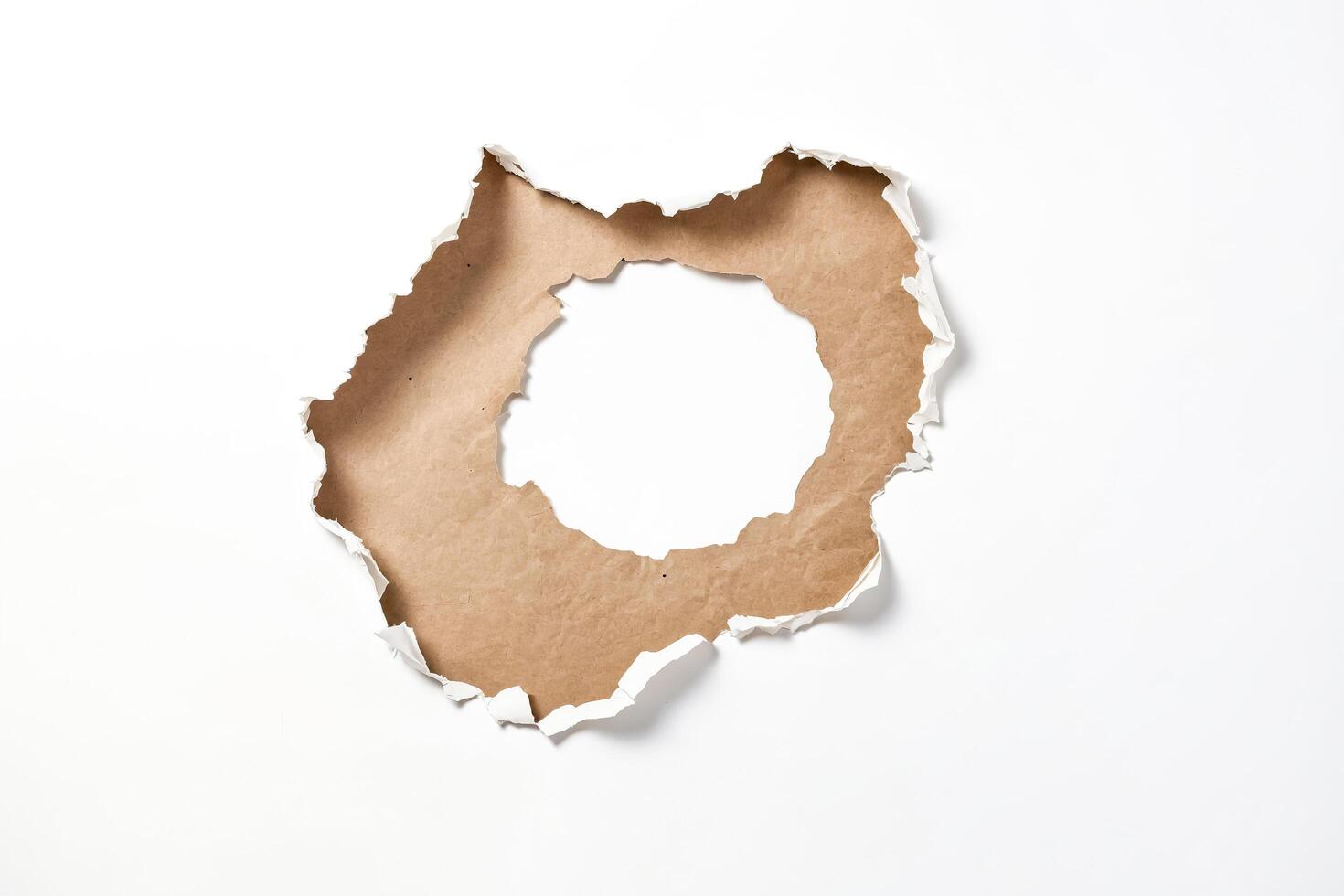 Torn paper revealing a brown background photo