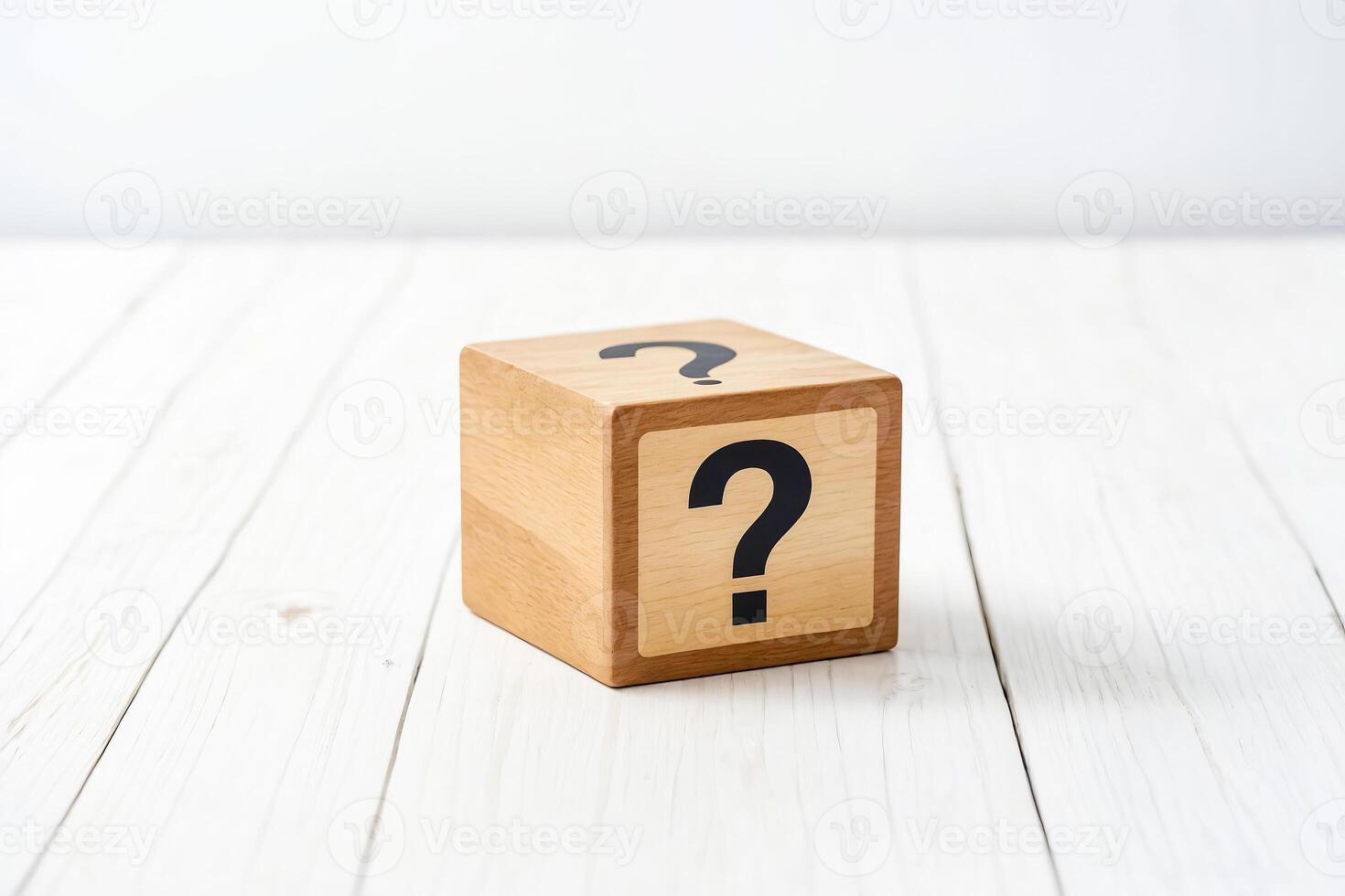 Wooden cube with a question mark on a white table photo