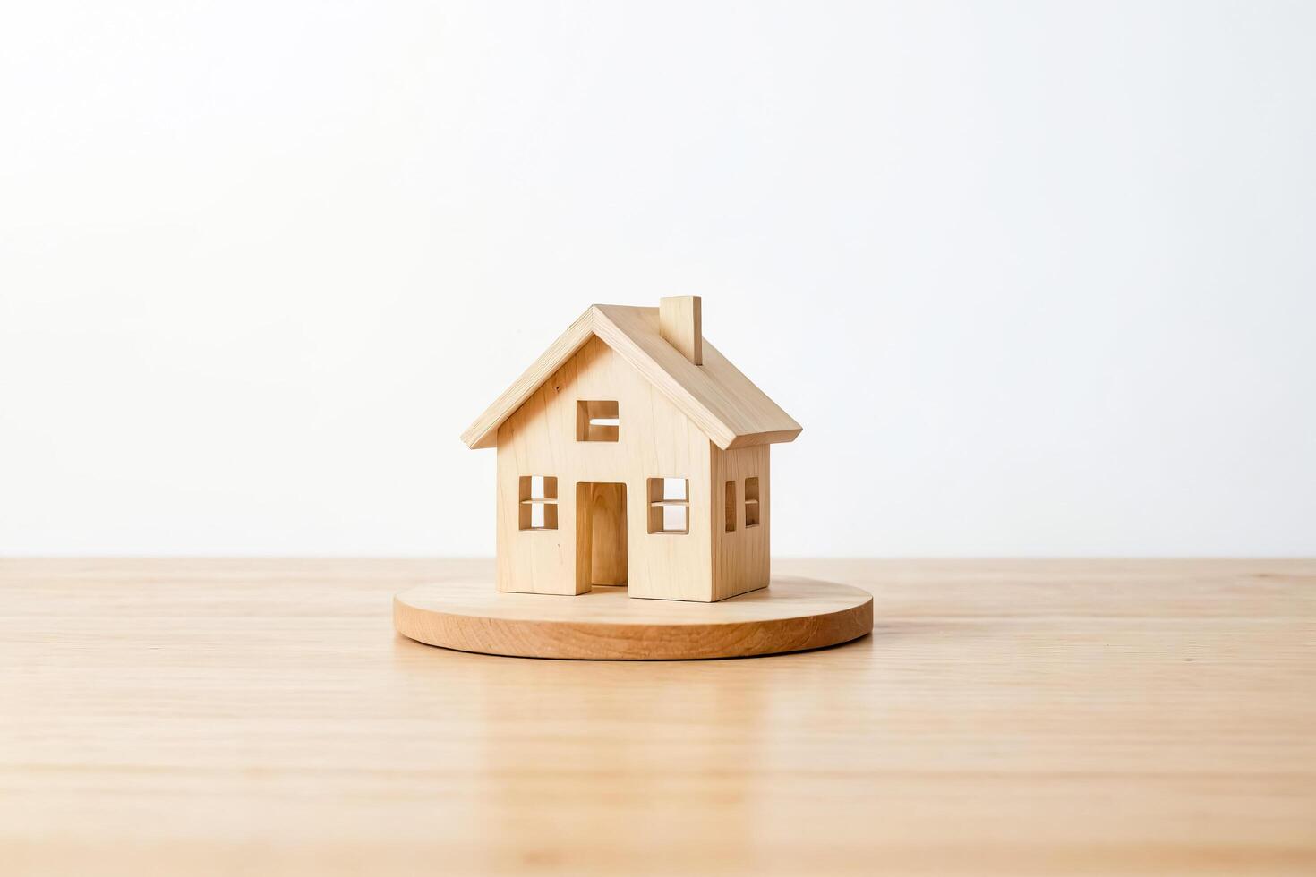 Wooden house model on wooden platform photo