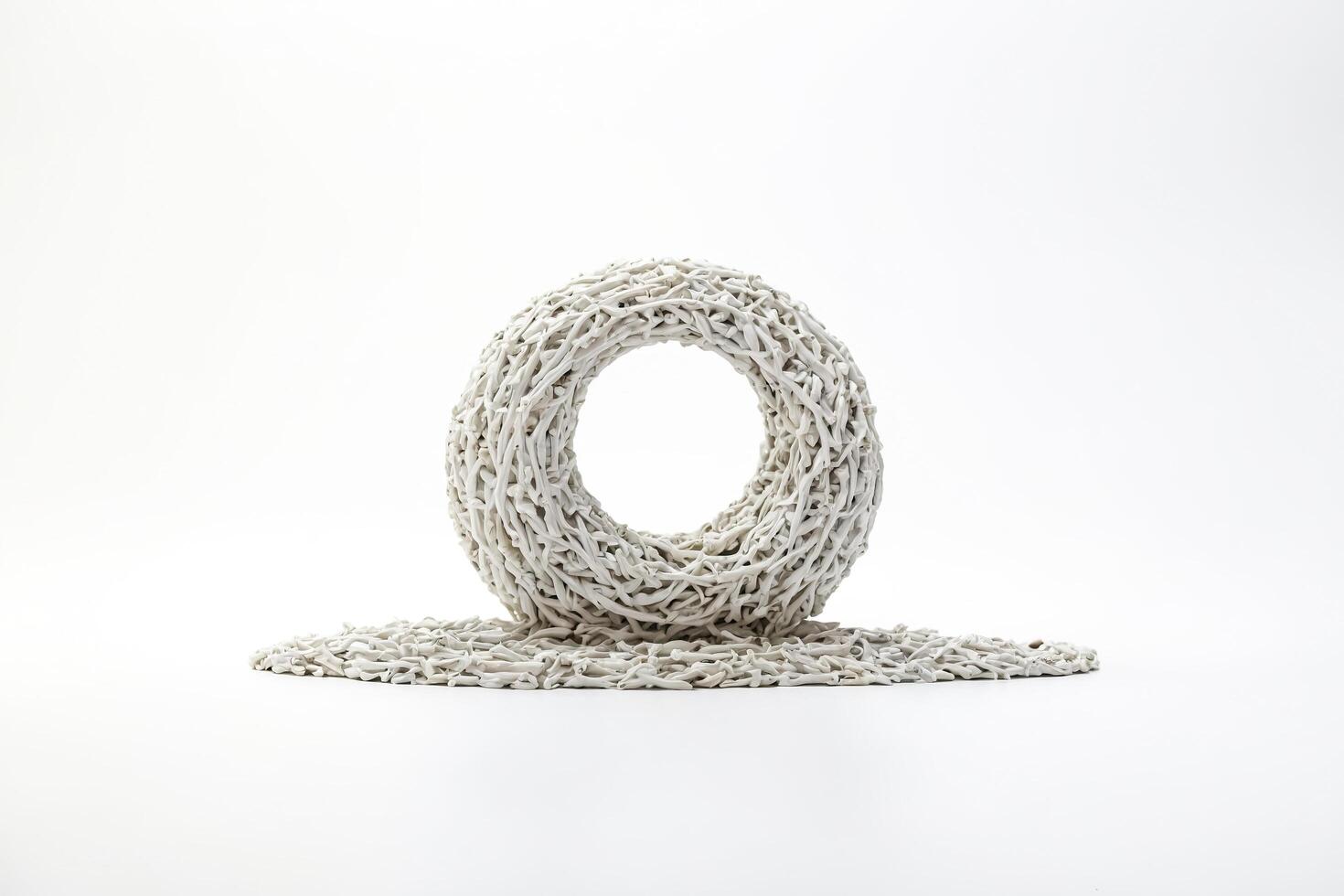 White woven ring on a white surface photo