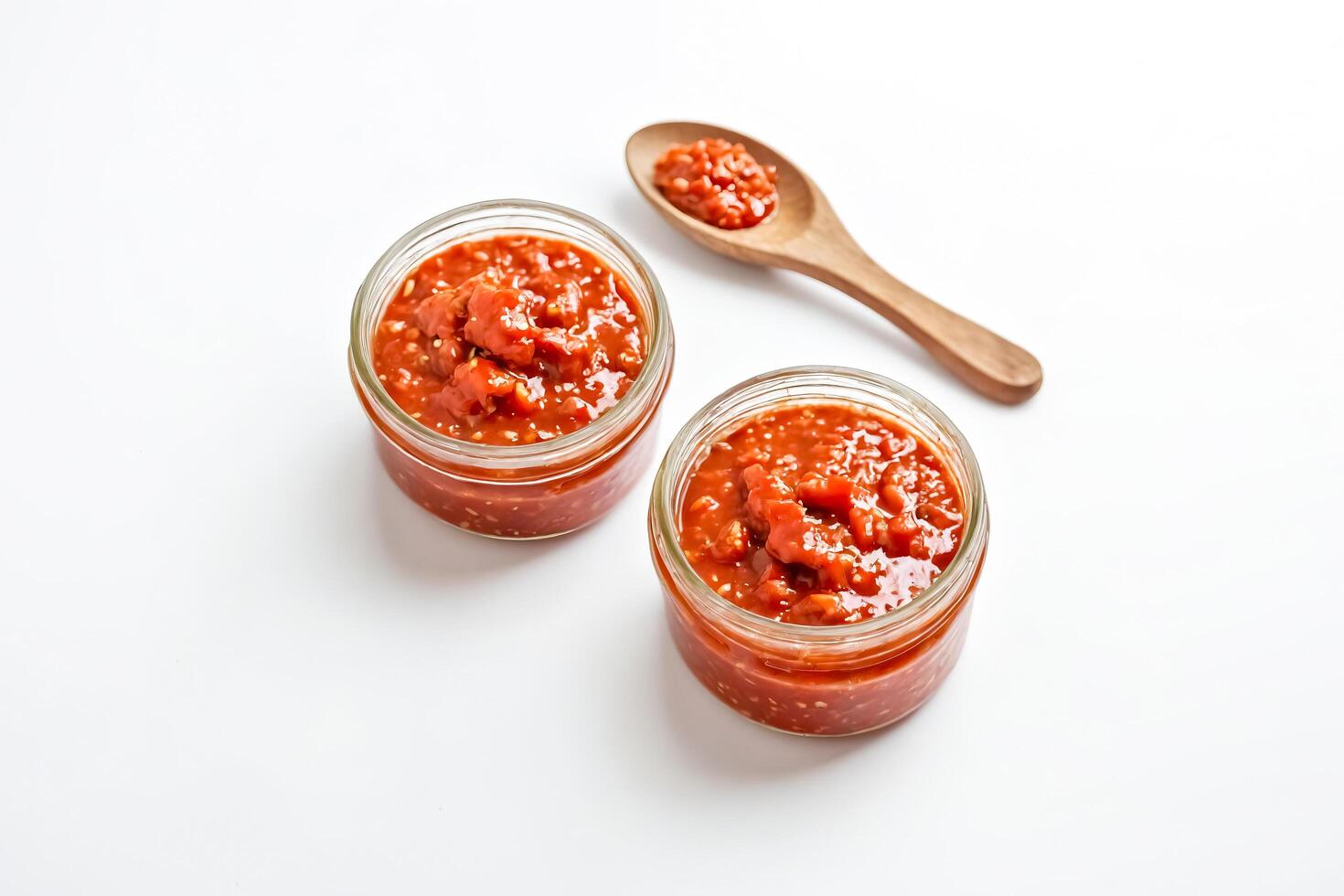 Jars of Homemade Tomato Jam with a Wooden Spoon photo