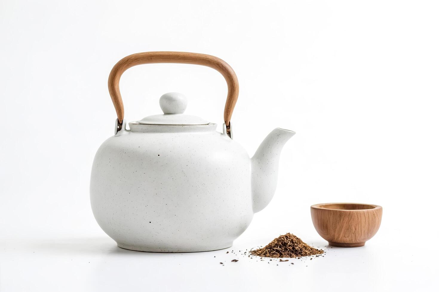 White Teapot with Wooden Handle and Loose Tea Leaves on White Background photo