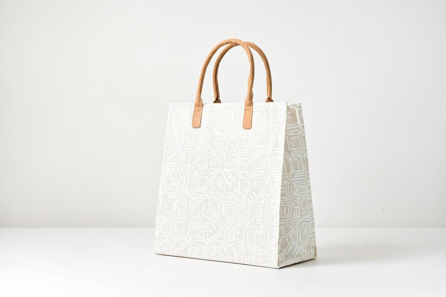 White Paper Bag with Geometric Pattern and Leather Handles photo
