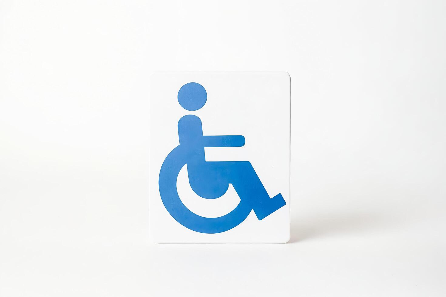 Blue Wheelchair Accessibility Sign on White Background photo