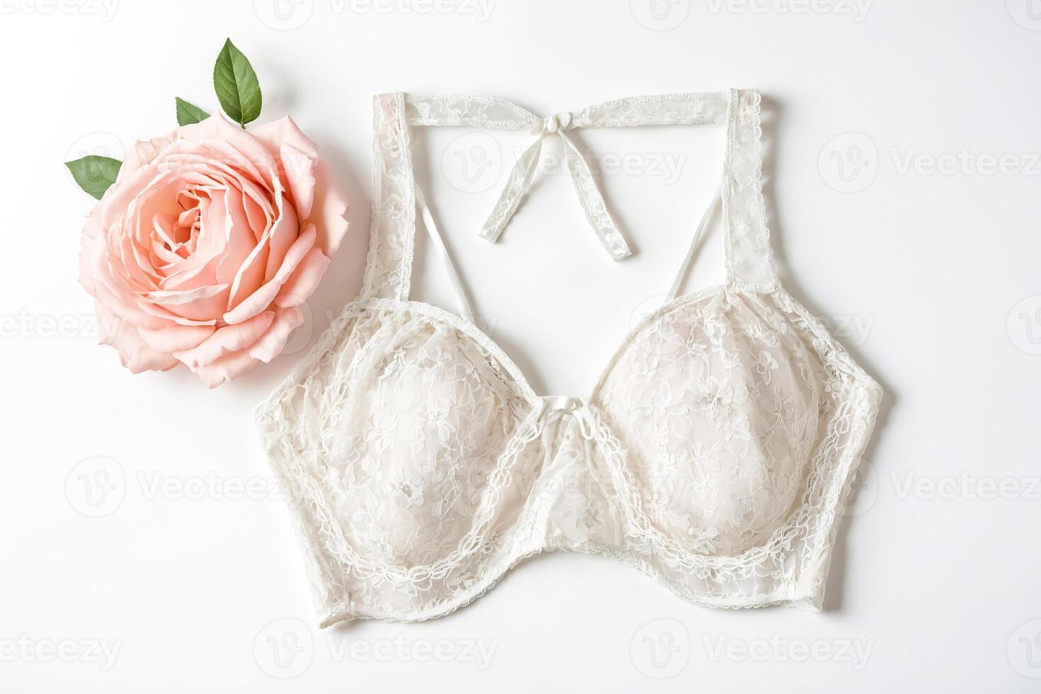 White Lace Bra with Pink Rose on White Background photo