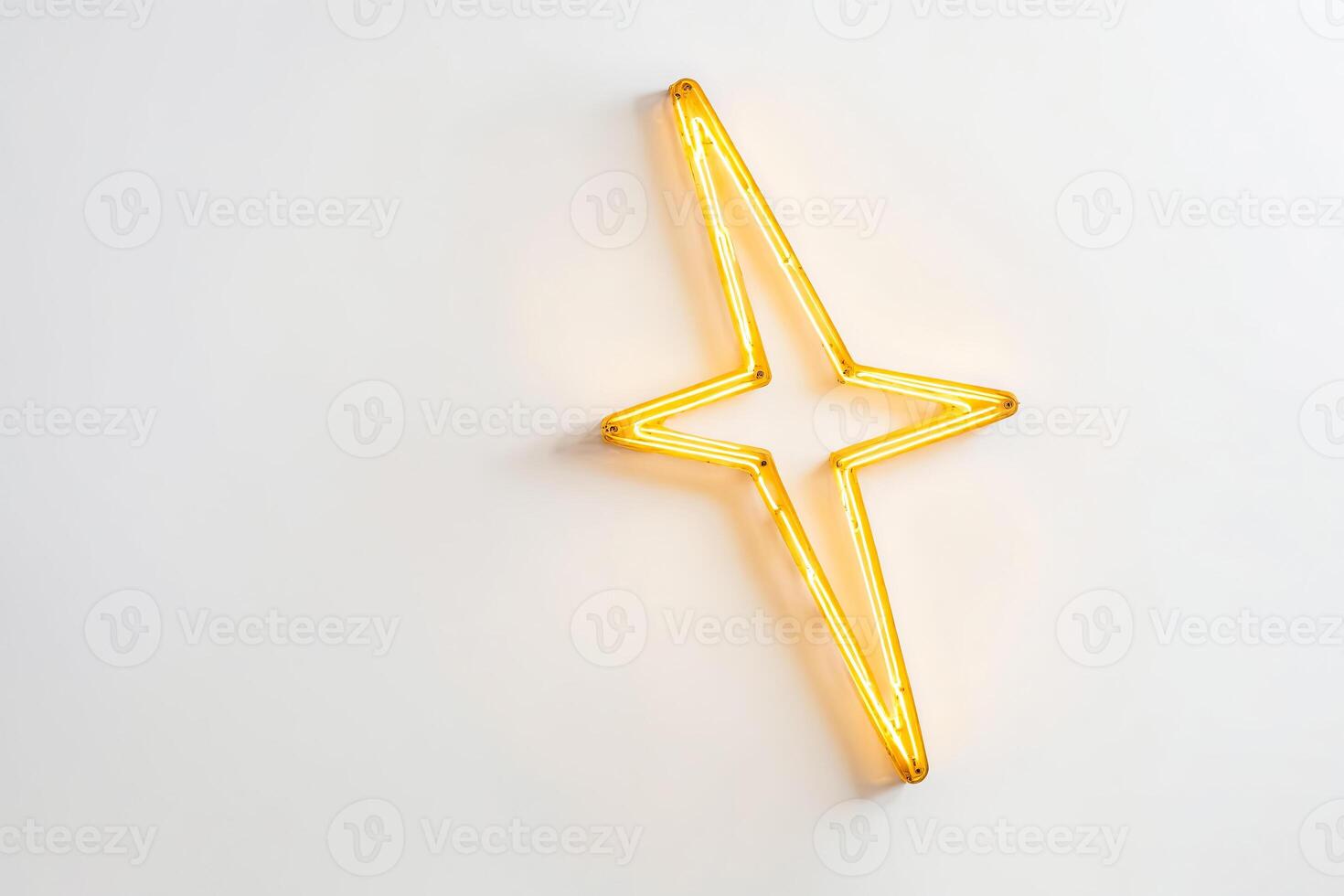 Golden Neon Star on White Wall photo