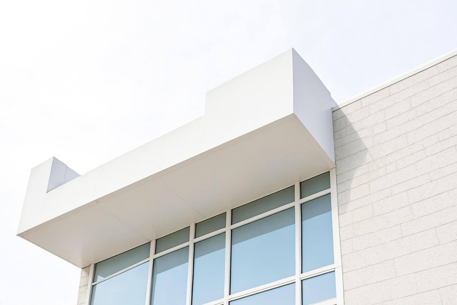 Minimalist Modern Building Exterior with Overhang and Large Windows photo