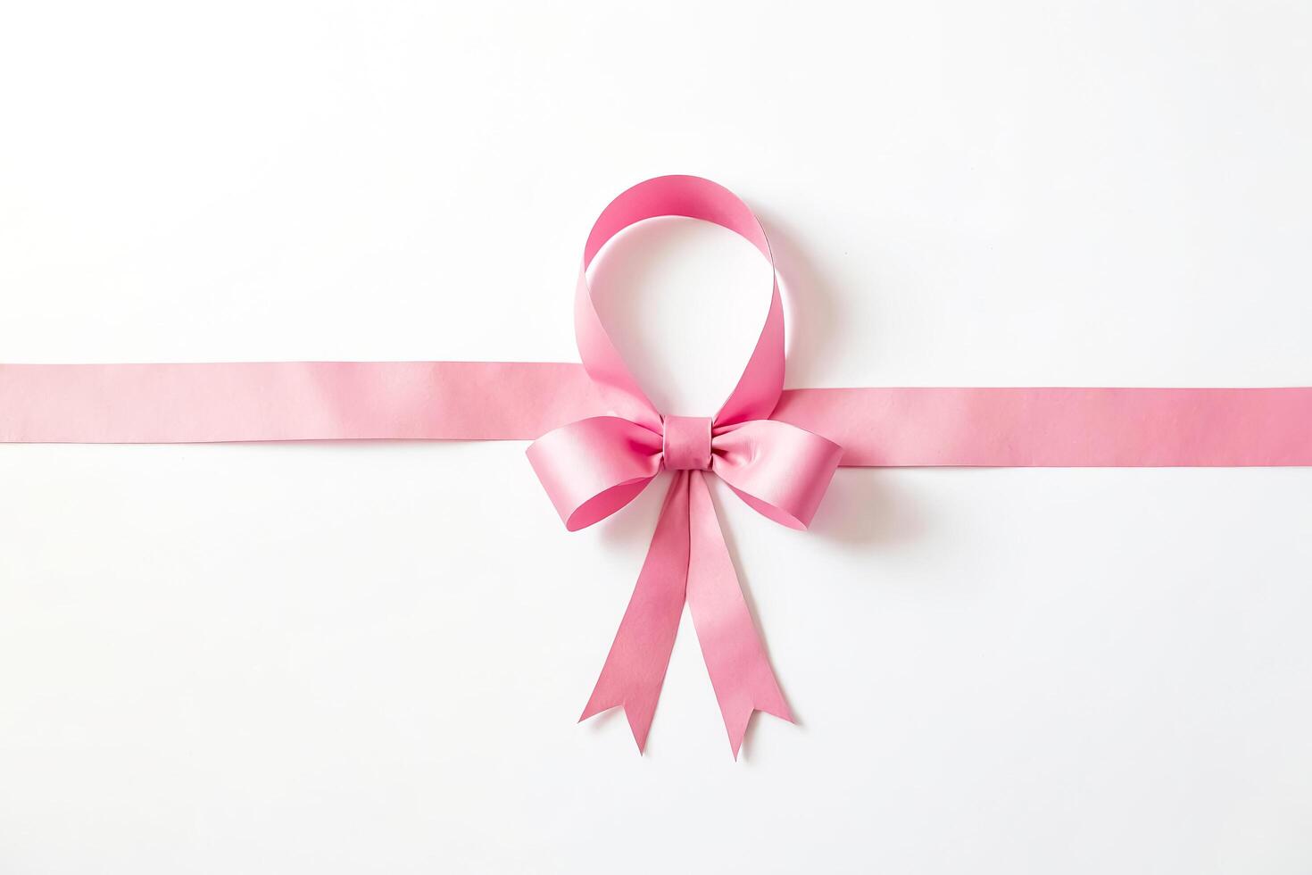 Pink ribbon bow on a white background photo