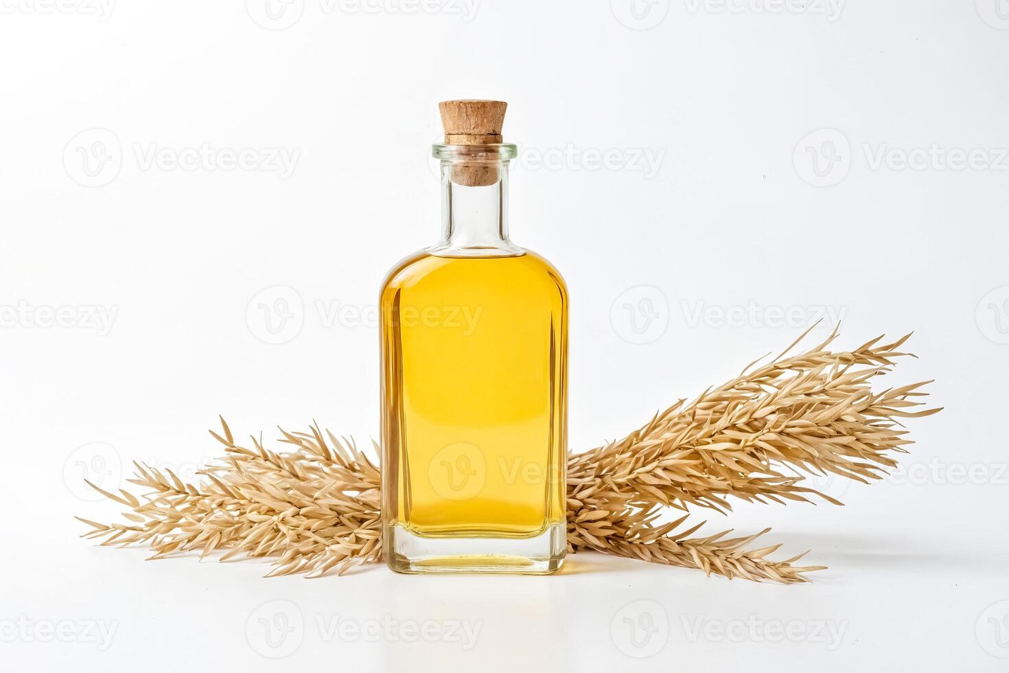 Wheat Oil in Glass Bottle with Wheat Sprig on White Background photo