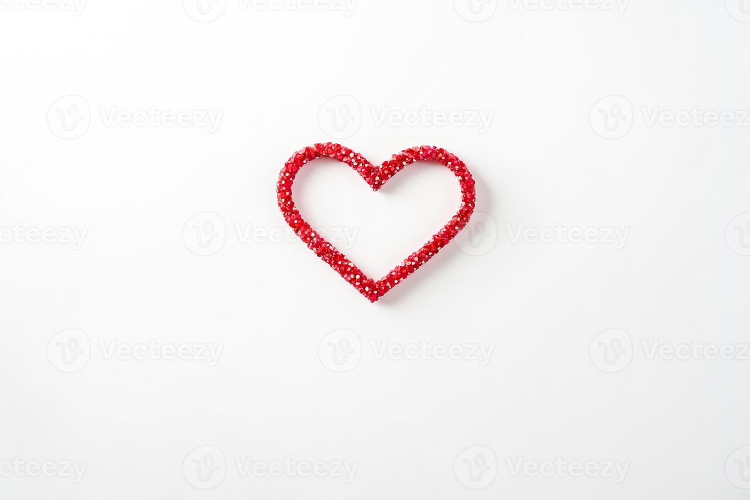 Red heart made of small red beads on white background photo