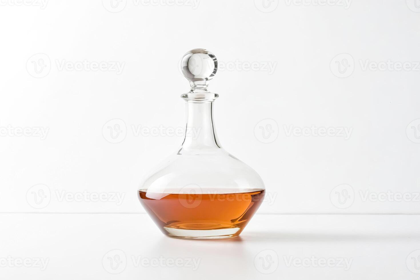 Decanter of amber liquid on white background photo