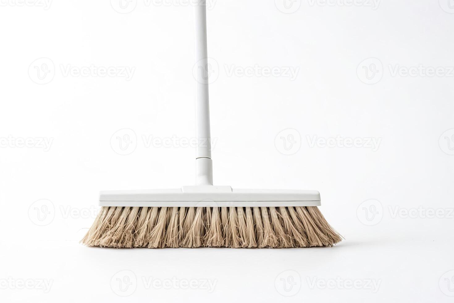 White broom with brown bristles on white background photo