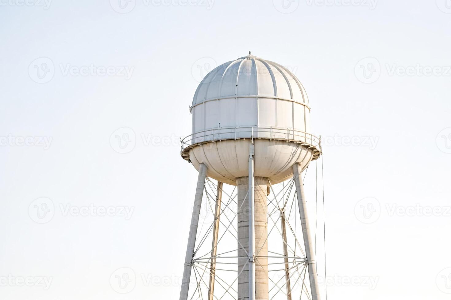White Water Tower Against a Bright Blue Sky photo
