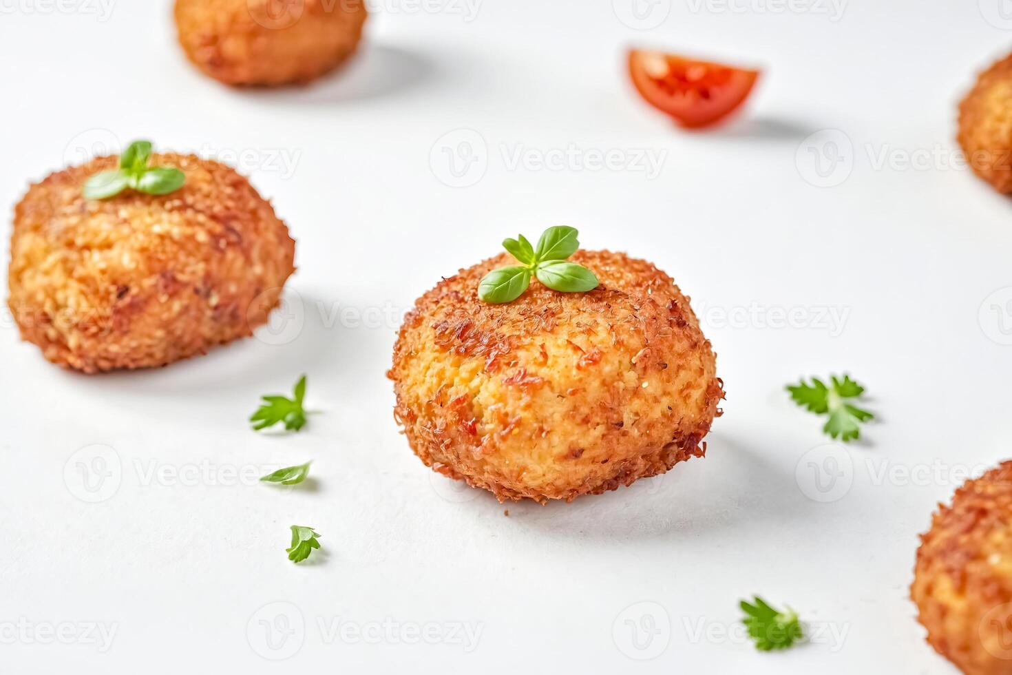 Close-up of Crispy Fried Arancini with Parsley Garnish photo