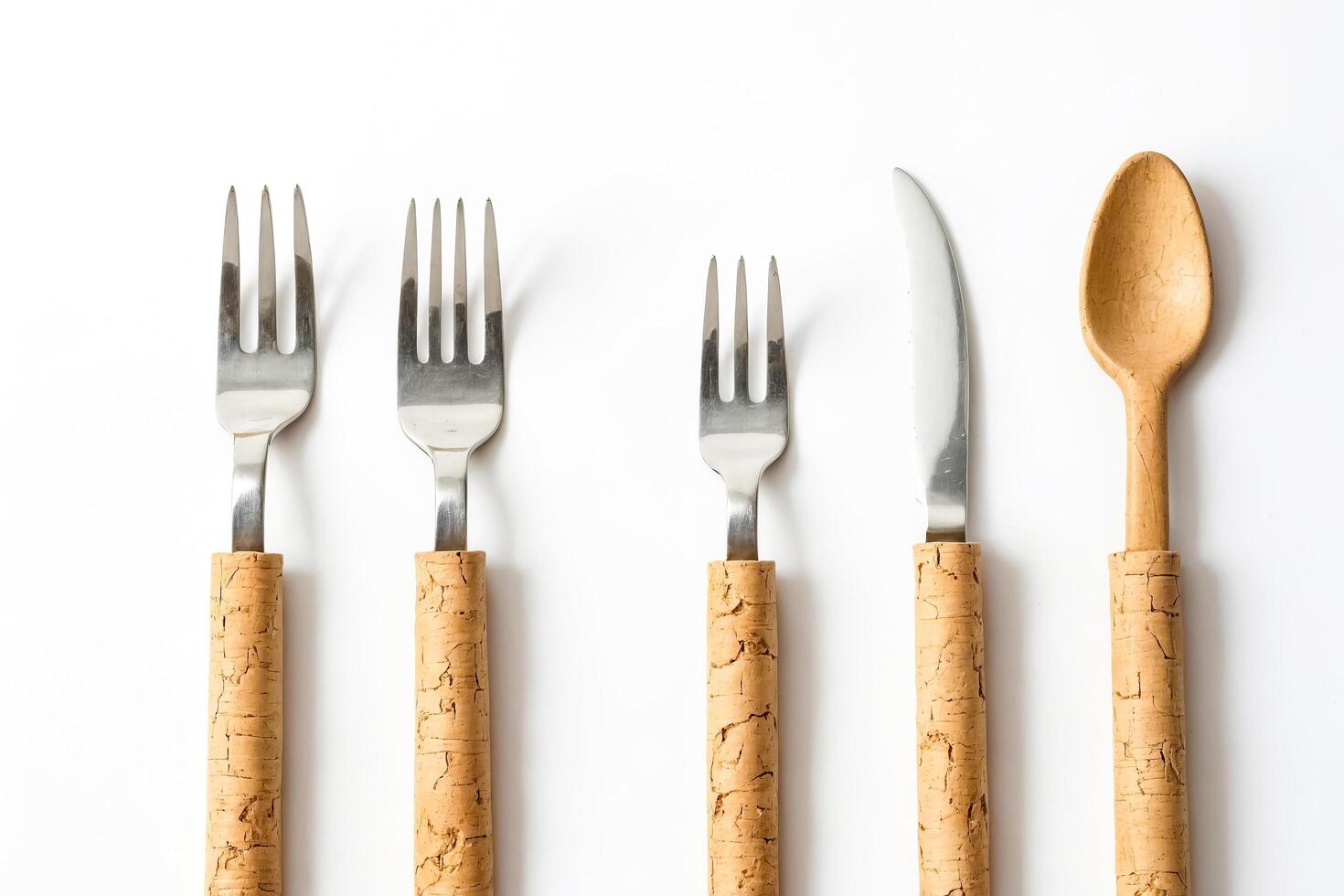 Fork, Knife, and Spoon with Cork Handles on White Background photo