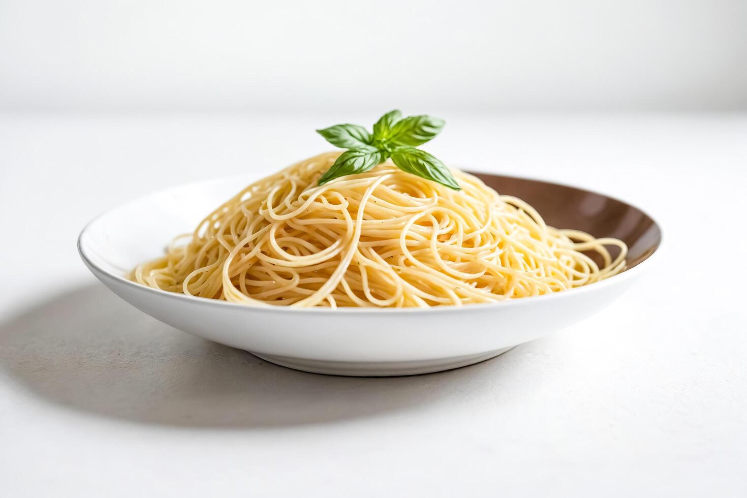 Simple spaghetti with basil in a white bowl photo