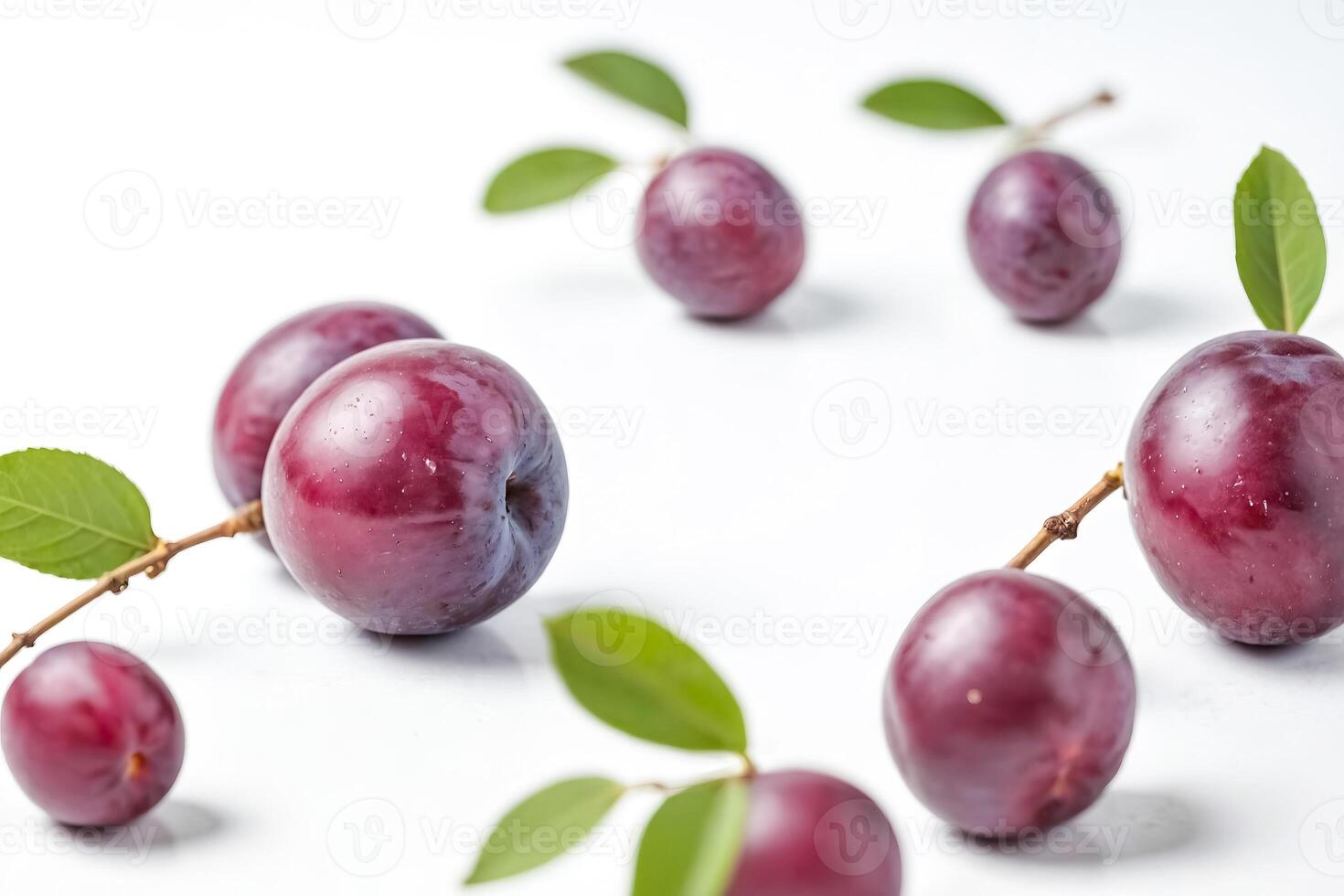 Fresh red plums with green leaves on white background photo