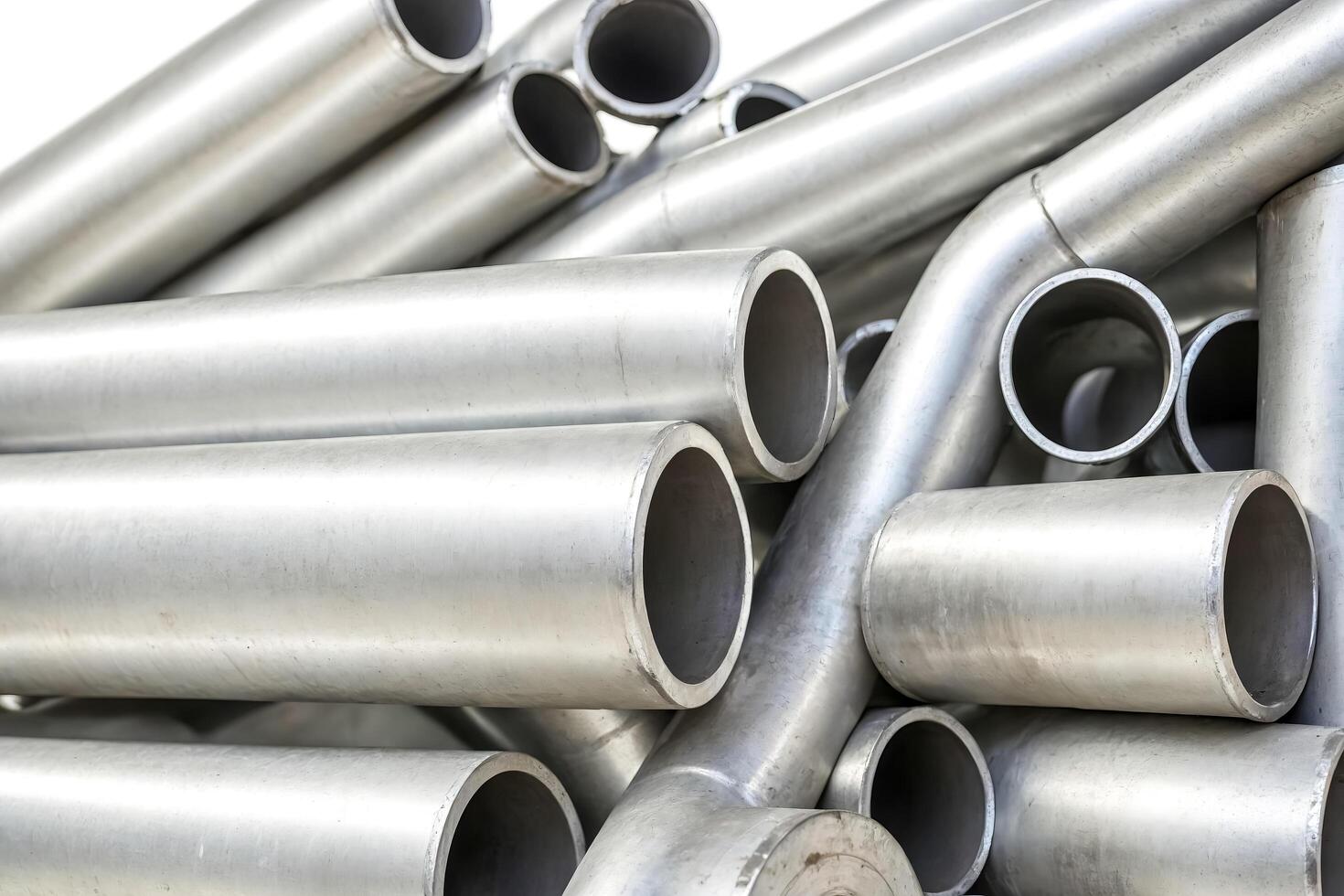 Closeup of stacked stainless steel pipes photo