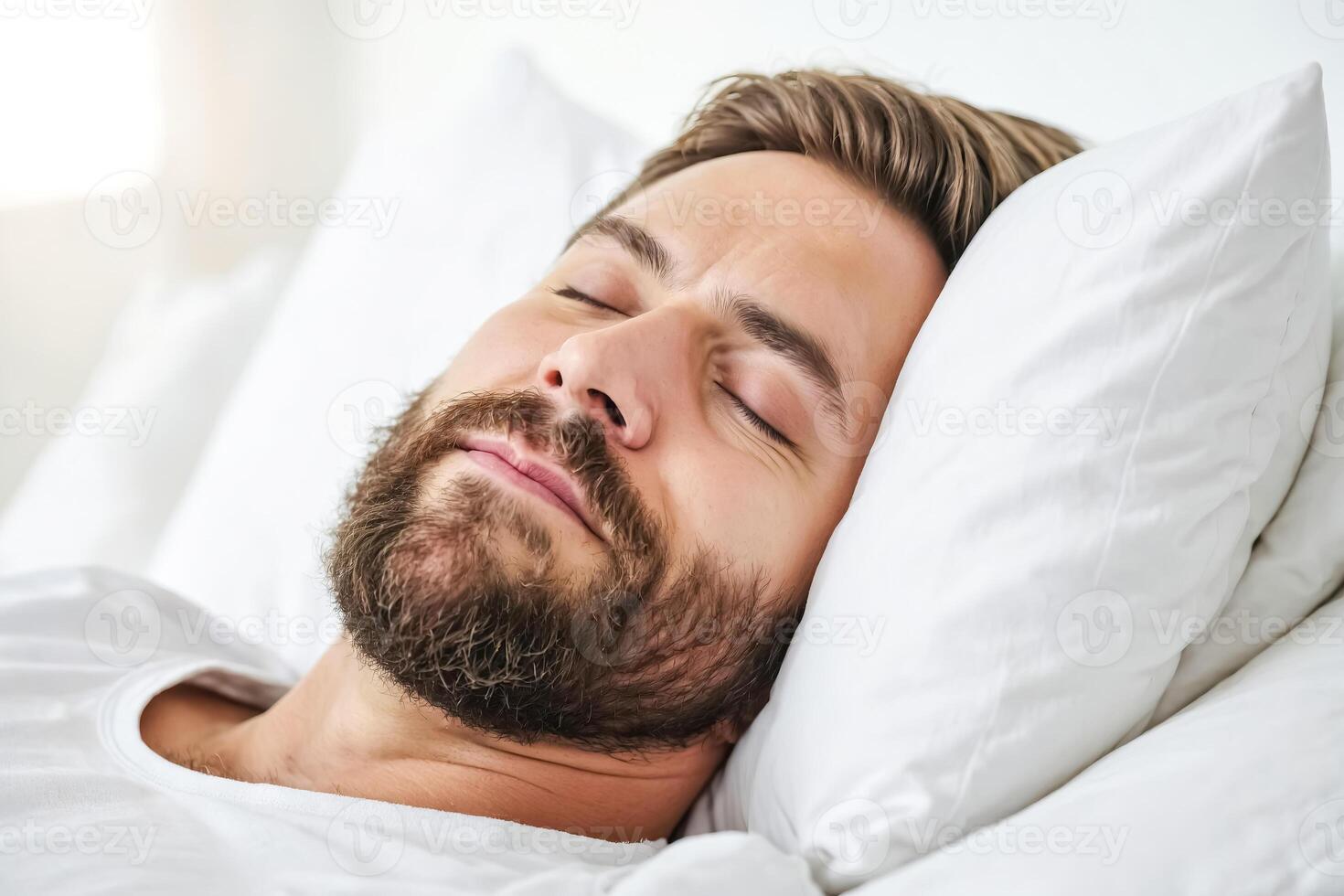 Young Man Sleeping in Bed with White Pillow and Sheets photo