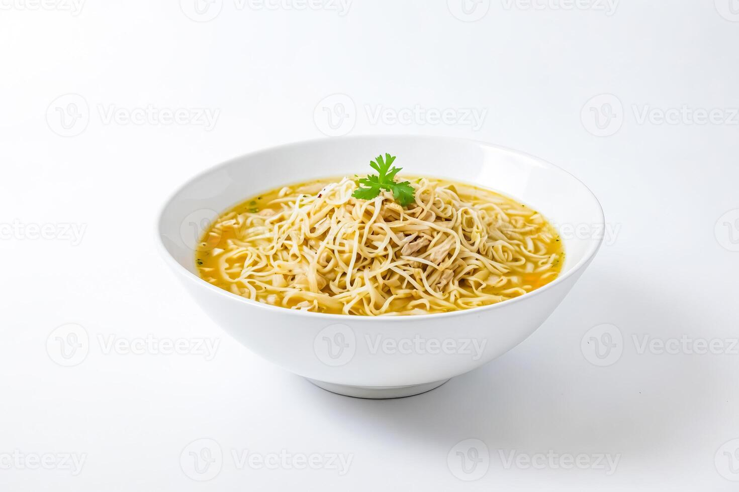 Bowl of noodle soup with parsley garnish photo