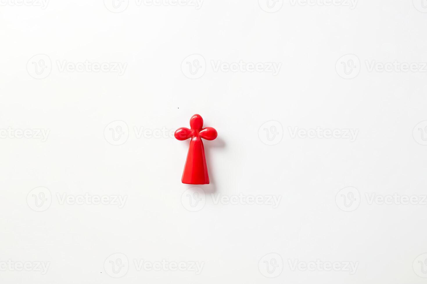 Red Plastic Cross on White Background photo