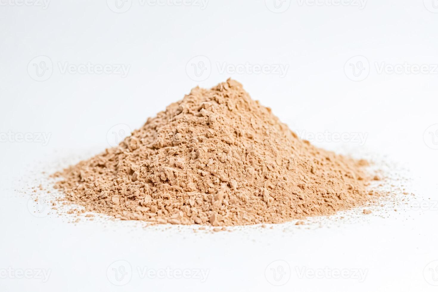 Pile of Brown Powder on a White Background photo
