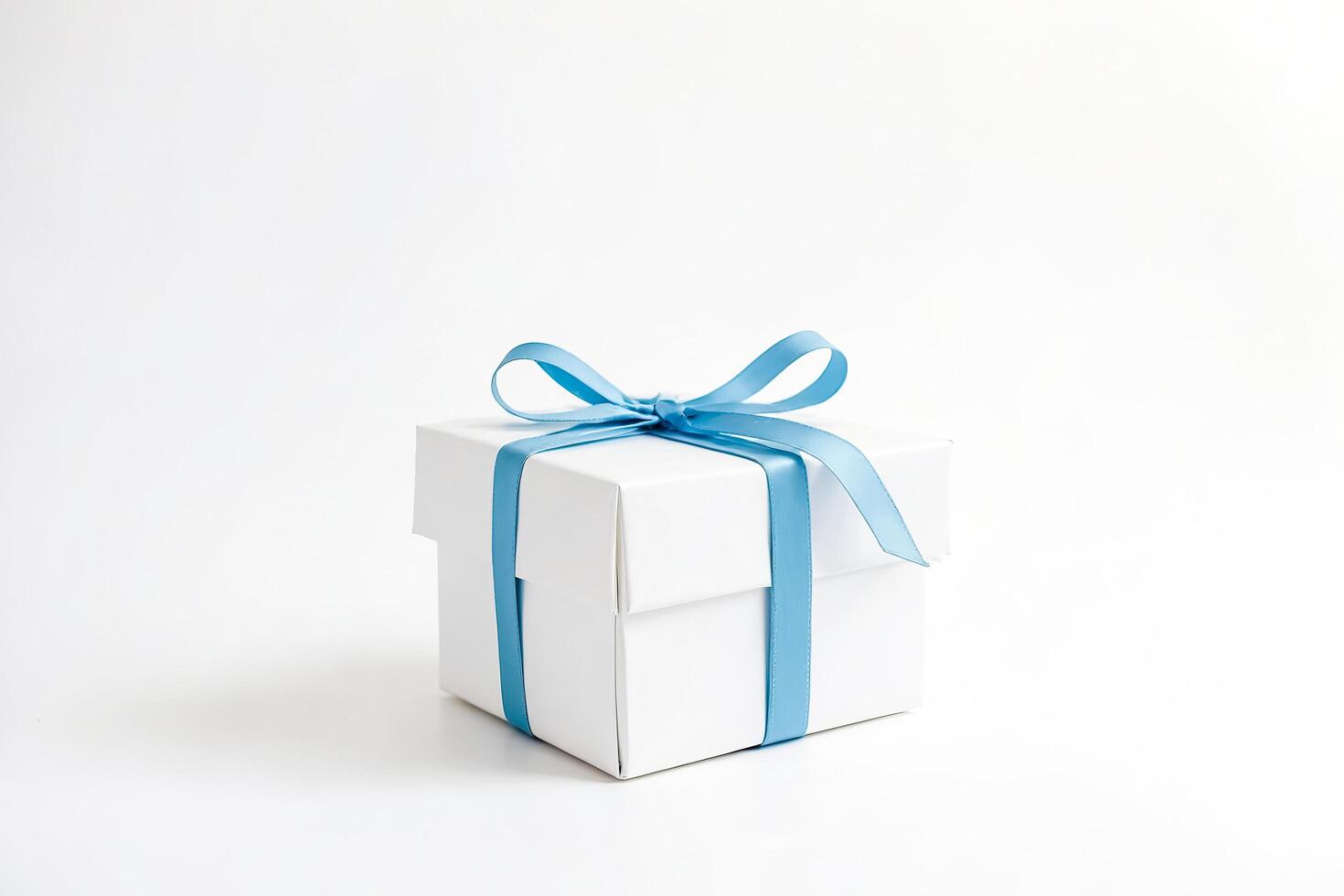 White gift box with blue ribbon photo