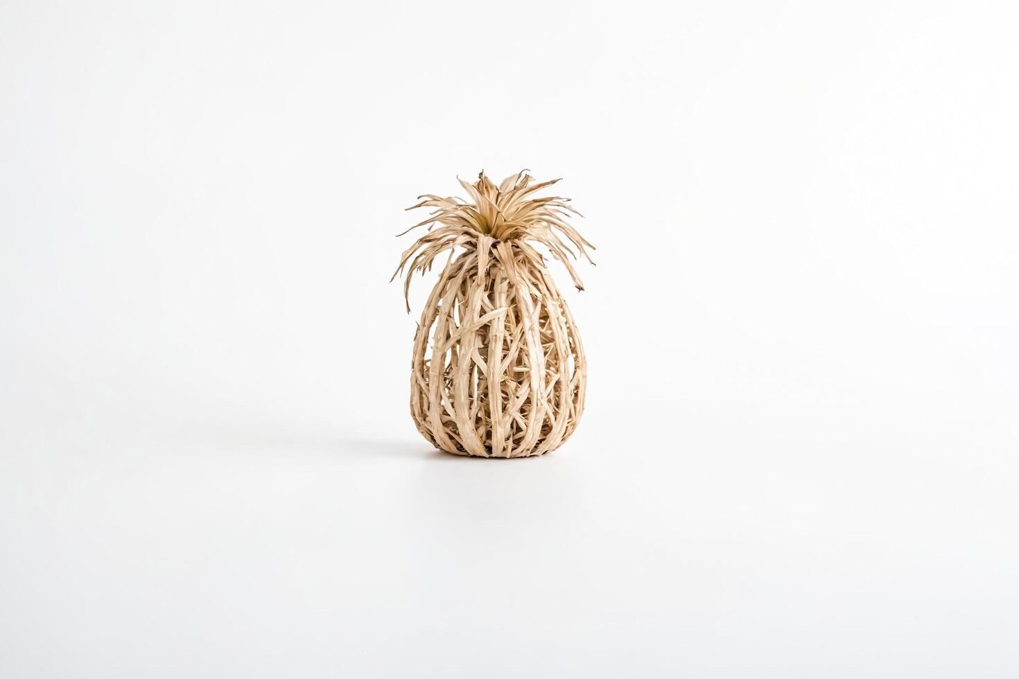 Wicker Pineapple Decoration on White Background photo