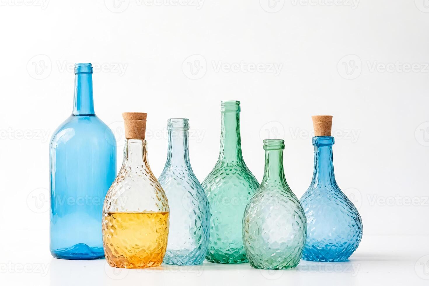 Glass bottles of different colors and shapes photo