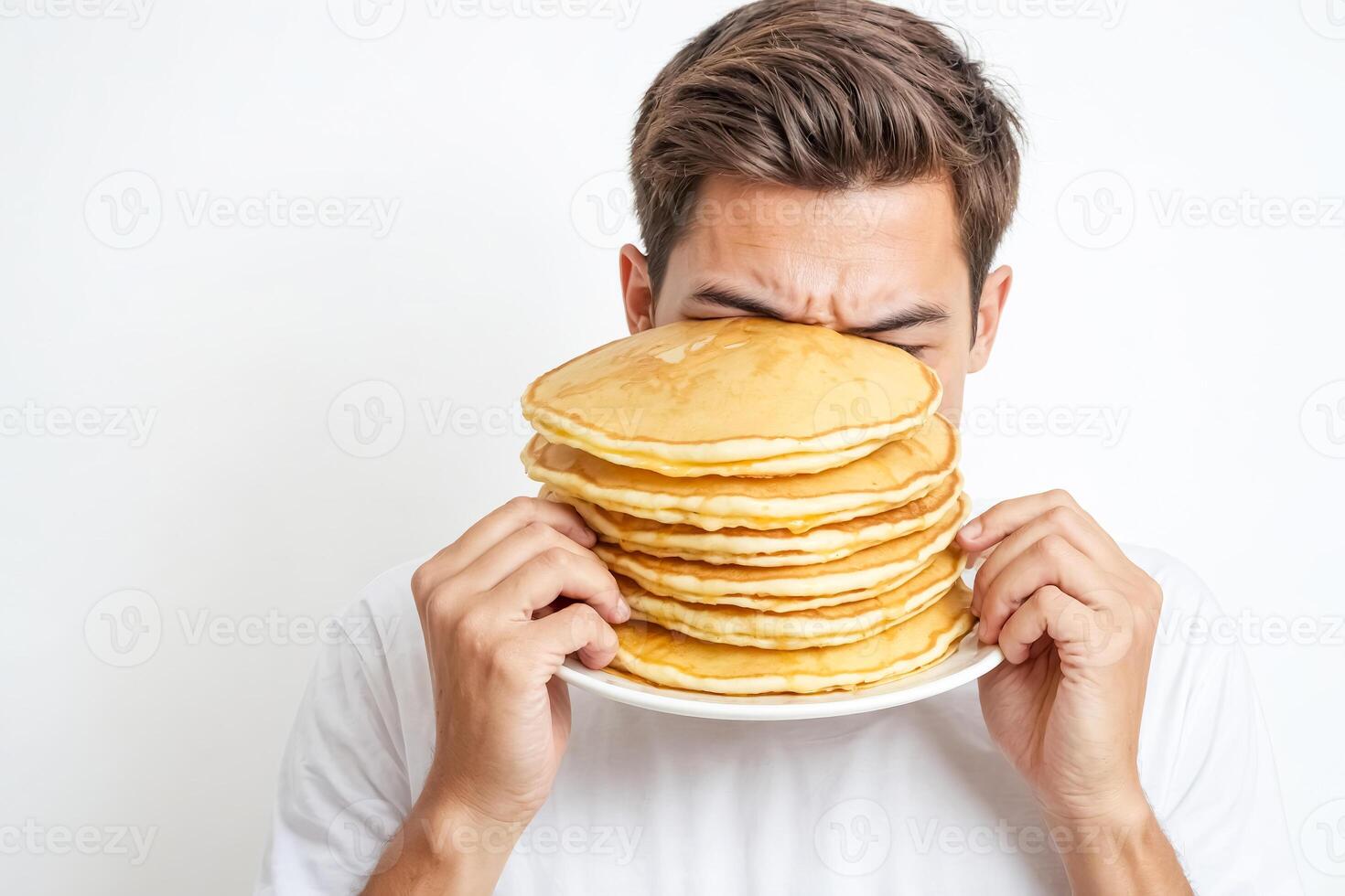 Man Holding a Stack of Pancakes in Front of His Face photo