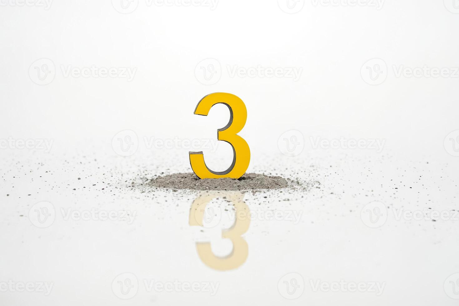 Yellow Number 3 in a Pile of Sand photo