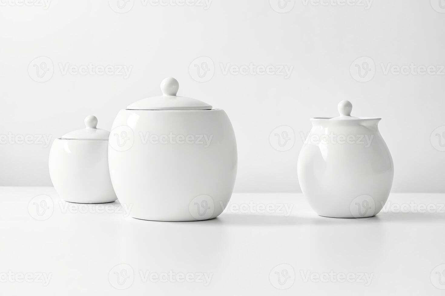 White Ceramic Sugar Bowl, Creamer, and Lid on a White Surface photo