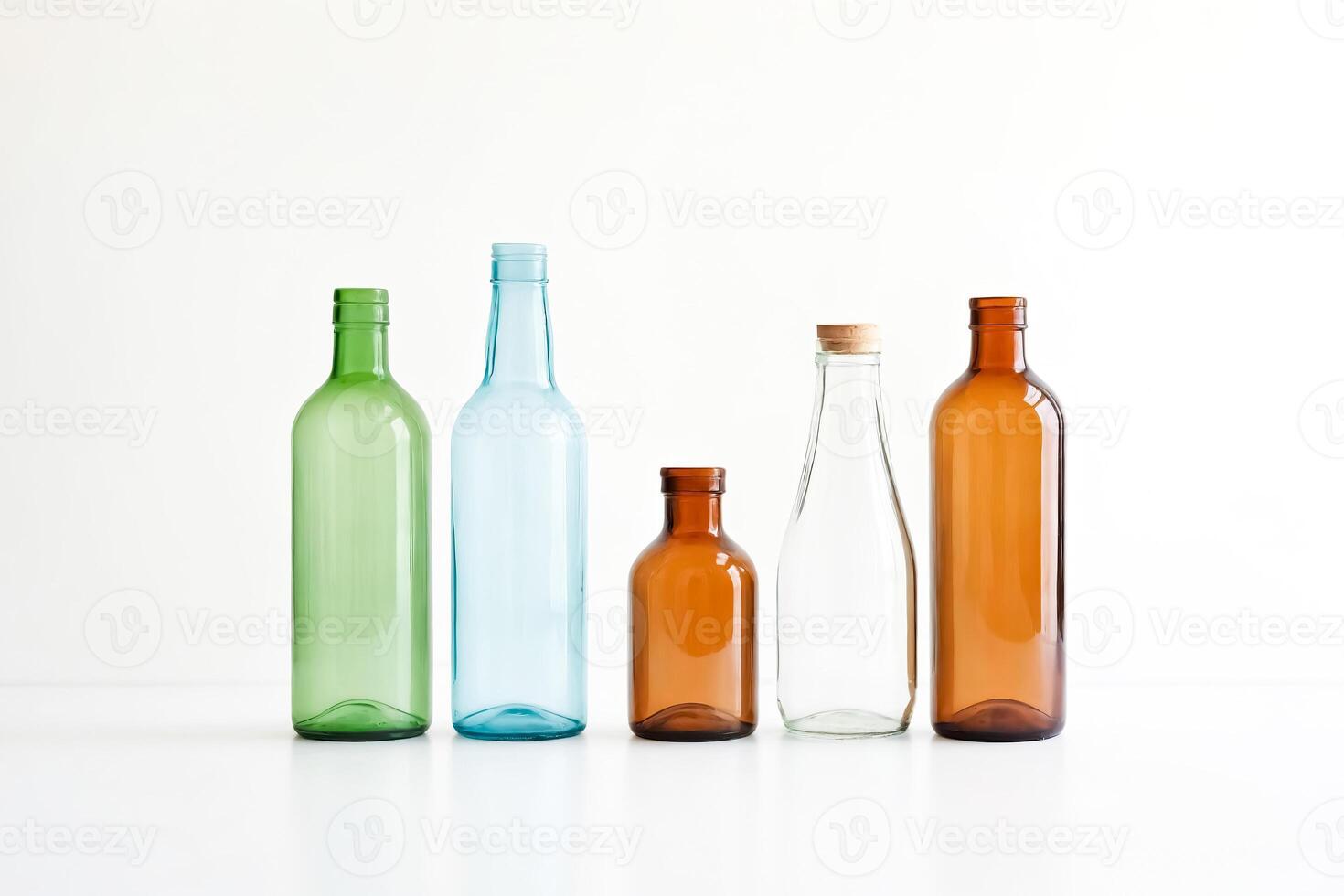 Five Empty Glass Bottles on a White Background photo