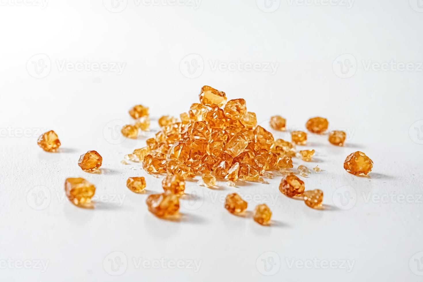 Closeup of a Pile of Brown Sugar Crystals on a White Surface photo
