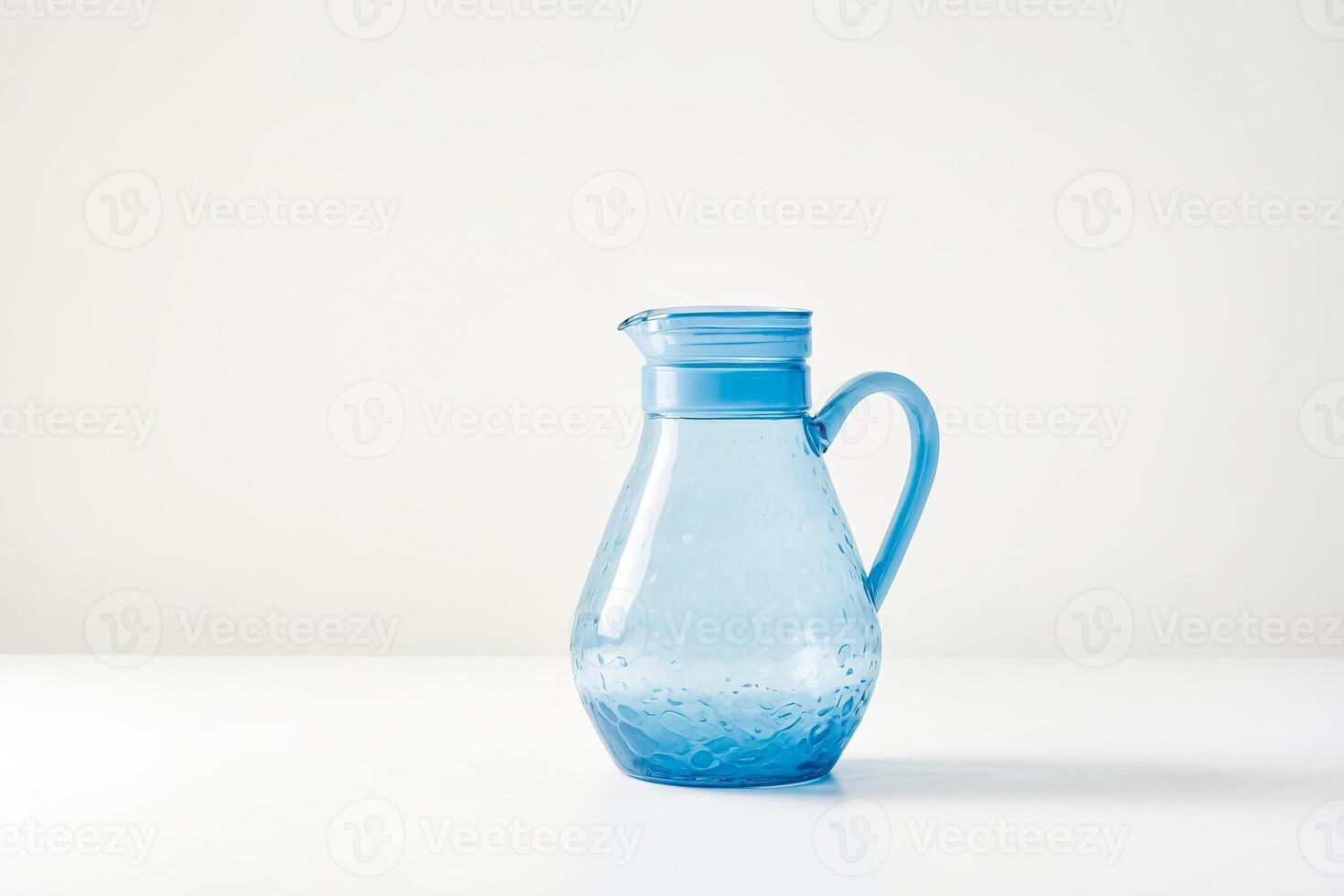 Blue Glass Pitcher on White Background photo
