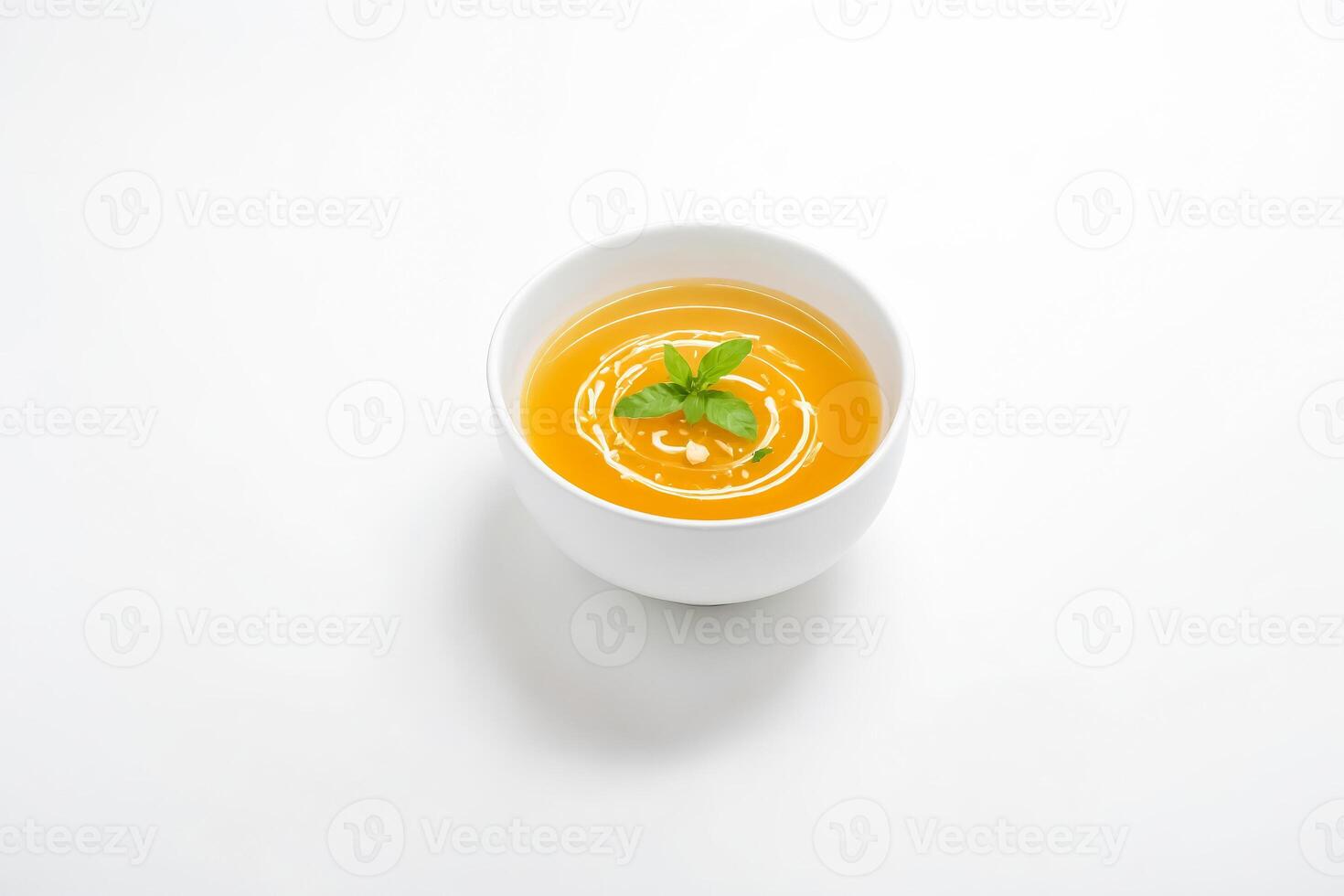 Bowl of Soup with a Single Leaf of Basil photo