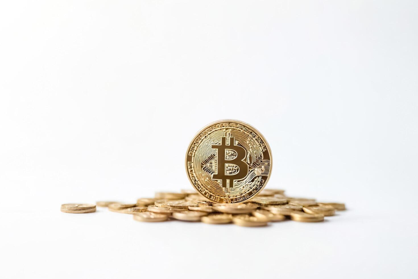Golden Bitcoin Coin on a Pile of Coins photo
