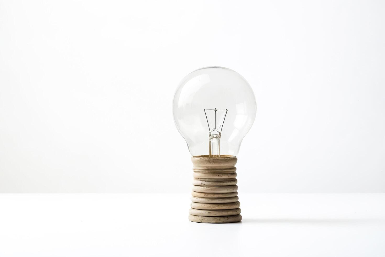 Single light bulb on a stack of wood rings photo