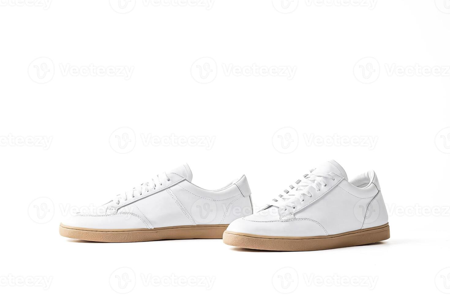 Pair of white leather sneakers with gum soles photo