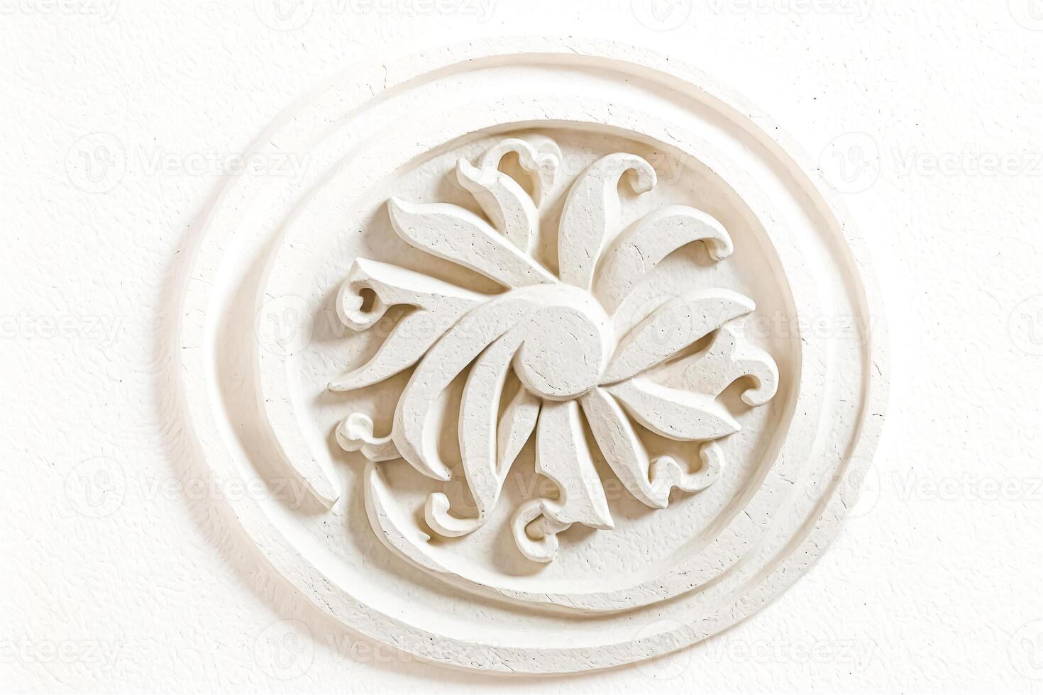 White Floral Relief on Wall photo