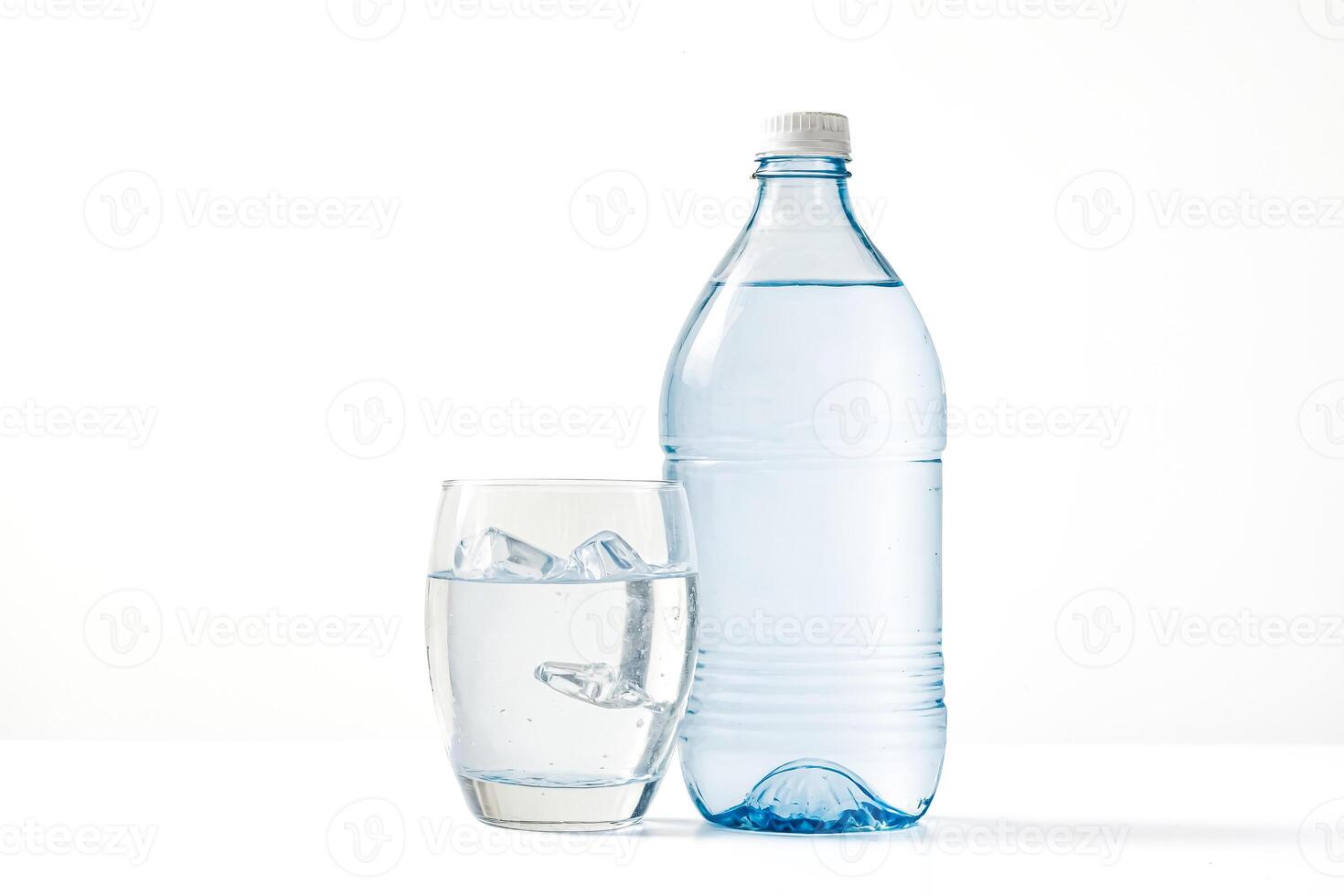 Glass of water with ice cubes and a bottle of water photo