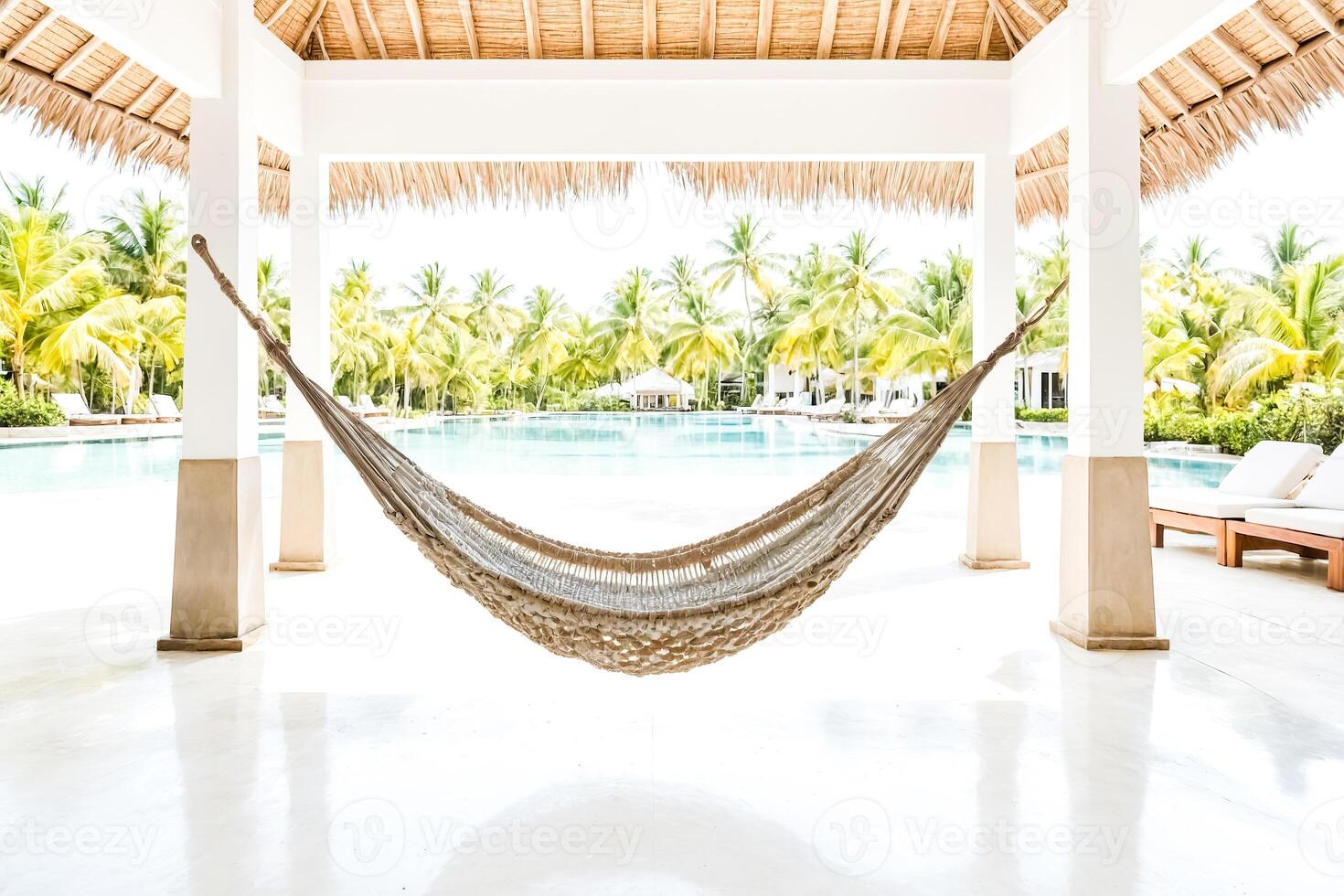 Hammock in front of a pool in a tropical resort photo