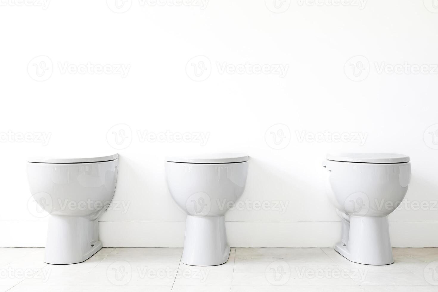 Three White Toilets in a Row photo