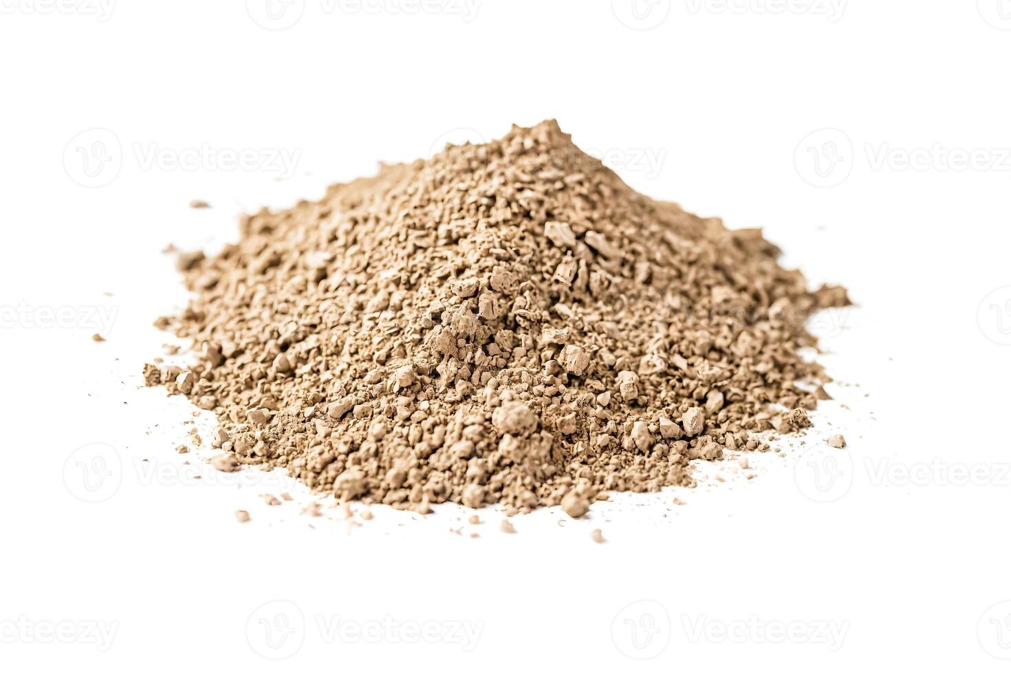 Close-up of a pile of brown powder on a white background photo