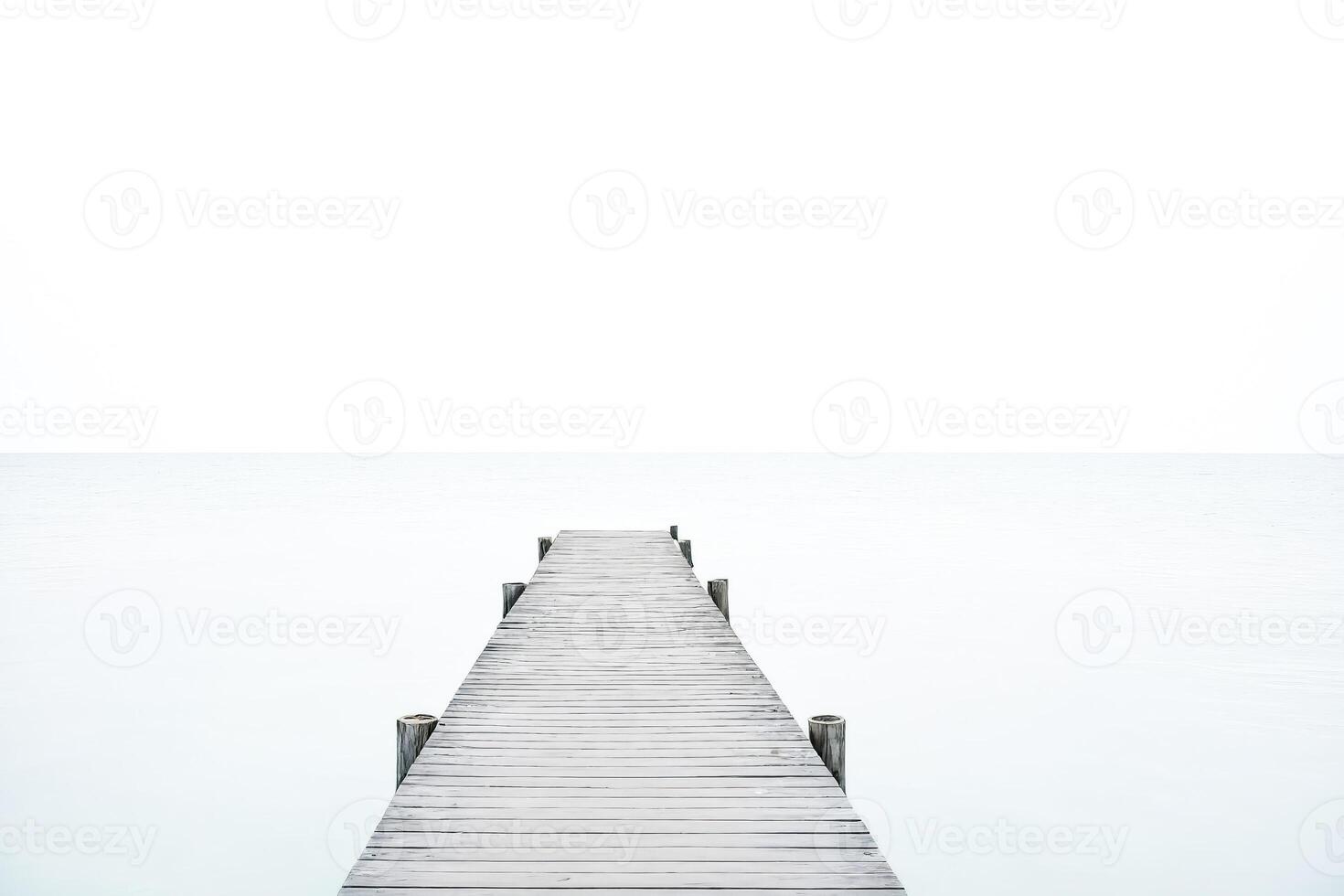 Wooden Dock Leading to a Hazy Horizon photo