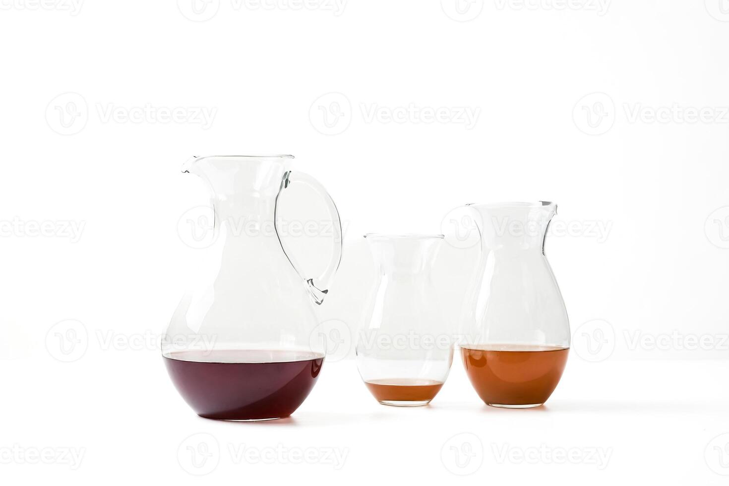 Glass Decanters with Red and Brown Liquids photo