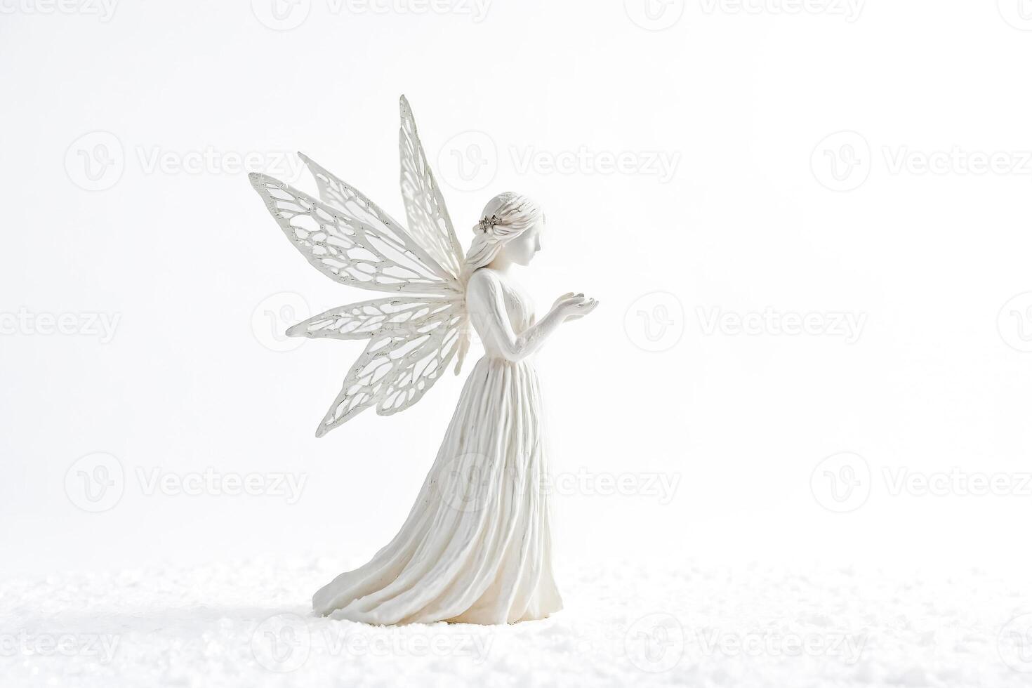 White Angel Figurine on a Snowy Surface photo